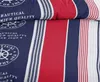 A close-up view of a nautical-themed fabric with stripes and text. Produktbild-Vorschau