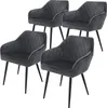 Four dark gray velvet dining chairs with diamond tufting and black metal legs are arranged in a staggered formation against a white background. Produktbild-Vorschau