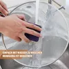 A hand is shown cleaning a mesh splatter screen under running water in a sink. Produktbild-Vorschau