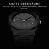 A close-up shot of a black watch with Arabic numerals on the dial, set against a black background. Text overlays describe the matte surface and a tactile sensation. Produktbild-Vorschau