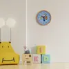A child's room with a clock, toy blocks, and a hippo-shaped chair. Voir les images du produit