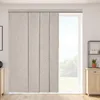 A room interior with a large window covered by beige vertical blinds. Voir les images du produit