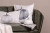 Pumpkins and a blanket are arranged on a green sofa. Produktbild-Vorschau