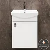 A white sink and cabinet against a dark marbled tile background. Produktbild-Vorschau