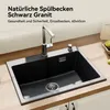 A black granite kitchen sink with a chrome faucet installed on a wooden countertop. Produktbild-Vorschau