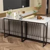 A console table with a marble top and black metal frame is placed behind a sofa in a living room. Produktbild-Vorschau