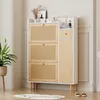 A modern shoe cabinet with cane detailing in a room setting. Produktbild-Vorschau