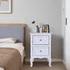 A bedroom scene with a nightstand next to a bed. Produktbild-Vorschau