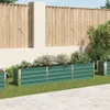 A row of green raised garden beds with plants in them, set against a wooden fence and a paved patio. Náhľad obrázku produktu