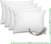 Four white feather pillows are arranged diagonally, with a single feather in the foreground. Náhľad obrázku produktu
