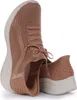 A pair of tan Skechers slip-on sneakers shown from a side angle against a white background. Produktbild-Vorschau
