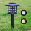A black solar garden light is shown in a grassy yard, with two circular insets showing the light on and off. Anteprima dell’immagine prodotto