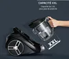 A hand is shown removing the dustbin from a black Rowenta vacuum cleaner. Produktbild-Vorschau