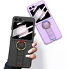 Two flip phones with cases, one black and one purple, are displayed against a white background. The black phone case has a gold ring and a textured strap with red accents. The purple phone case also has a gold ring and a strap with blue accents. Hands are  Produktbild-Vorschau