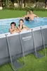 A family is enjoying themselves in an oval-shaped above-ground swimming pool set up on a grassy lawn. Anteprima dell’immagine prodotto
