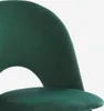 A close-up view of a dark green upholstered chair, focusing on the curved backrest and seat. Anteprima dell’immagine prodotto