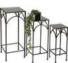 Three black metal plant stands of varying heights are arranged on a white background. A potted plant with trailing vines sits on the middle stand. Produktbild-Vorschau