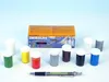 A set of paint pots and a box of paints are arranged on a white surface with a pen in the foreground. Produktbild-Vorschau