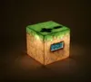 A Minecraft-themed alarm clock cube is illuminated from within, casting a warm glow. Náhľad obrázku produktu