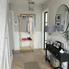 A hallway with a coat rack, console table, and mirror. Podgląd zdjęcia produktu