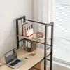 A close-up view of a desk with a laptop, books, and a small radio on a shelf. Produktbild-Vorschau