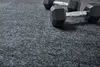 Two dumbbells are placed on a grey carpeted surface. Produktbild-Vorschau