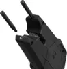 A close-up, angled view of a black fishing bite alarm with two black cylindrical attachments. One attachment is inserted into the device, while the other is positioned to the left, separate from the device. Náhľad obrázku produktu