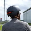 A person wearing a helmet with integrated lights while outdoors. Anteprima dell’immagine prodotto