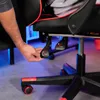 A close-up shot of a person's hand adjusting a lever on a gaming chair. Náhled obrázku produktu