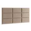 A beige upholstered headboard with nine square panels. Podgląd zdjęcia produktu