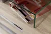 A close-up shot of a magazine on a wooden surface with a glass edge. Produktbild-Vorschau