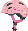A pink children's helmet with fairy and mushroom decorations, shown from a side-angle. Produktbild-Vorschau