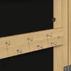 A close-up view of a wooden board with several hooks attached, mounted against a black background. Produktbild-Vorschau