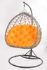 A hanging egg chair with an orange cushion, presented against a white background.
