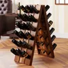 A wooden wine rack filled with wine bottles, placed in a room with a leather chair and a table. Produktbild-Vorschau
