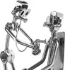 A close-up shot of a metal sculpture depicting a doctor examining a patient. Anteprima dell’immagine prodotto