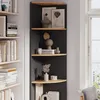 A corner shelf unit filled with books and decorative items, placed next to a window. Podgląd zdjęcia produktu