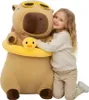 A young girl hugging a large capybara plush toy. Anteprima dell’immagine prodotto