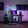 A gaming setup with a desk, chair, computer, and wall decorations. Voir les images du produit