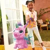 A young girl is playing with a pink unicorn toy in a backyard. Náhled obrázku produktu
