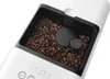A close-up view of coffee beans in a coffee machine hopper. Voir les images du produit