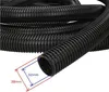 A coiled black corrugated hose with measurement indicators. Produktbild-Vorschau