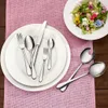 A table setting with plates, cutlery, and a salad. Anteprima dell’immagine prodotto