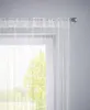 A close-up view of a white string curtain hanging in front of a window, with trees visible outside. Produktbild-Vorschau