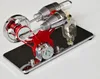A close-up studio shot of a Stirling engine model on a reflective base. Náhľad obrázku produktu