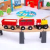A wooden toy train set with multiple wagons, a bridge, and other accessories arranged on a white surface. Produktbild-Vorschau