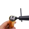 A hand holds a rotary tool with a chuck and a key. Podgląd zdjęcia produktu