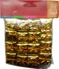 A package of small, gold-colored gift decorations. Náhled obrázku produktu