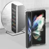 A folding smartphone in a black case is shown, with a reflection of the phone in a circular mirror. Náhled obrázku produktu