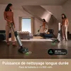 Two women and a dog in a modern living room, with two vacuum cleaners in use. Produktbild-Vorschau